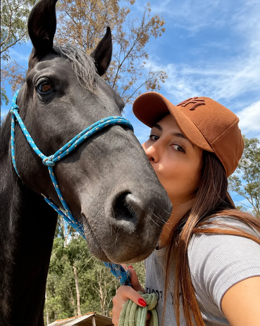 Camila Oliveira Camila Oliveira ao lado de um cavalo ao ar livre